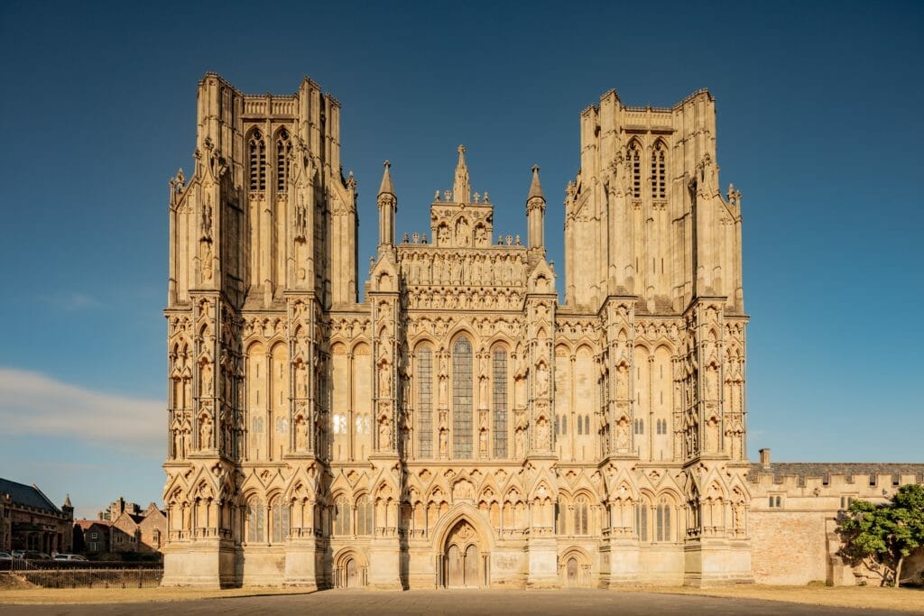 Photo of Wells Cathedral during the day, with blue sky.