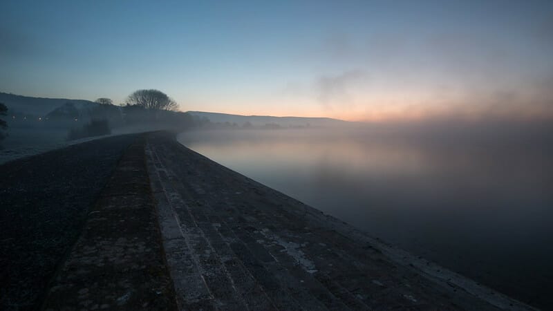 A misty picture of Cheddar Reservoir in early morning light. 