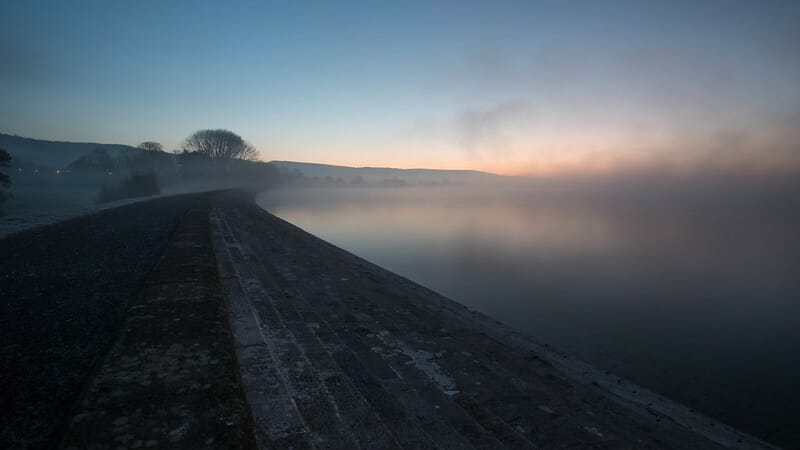 A misty picture of Cheddar Reservoir in early morning light.  