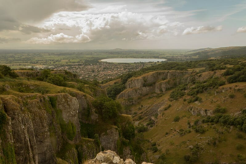A landscape photograph of the Cheddar Gorge and the Cheddar Reservoir in the background